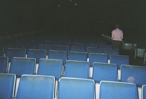 A face of a lamb or calf seems to appear against a seat in the theater. The building had been built on the site of the Hawkeye Stock Farm. So is it a animal spirit or just a funny wear spot on the fabric seat in the lower right? It has what looks like eyes and big floppy ears